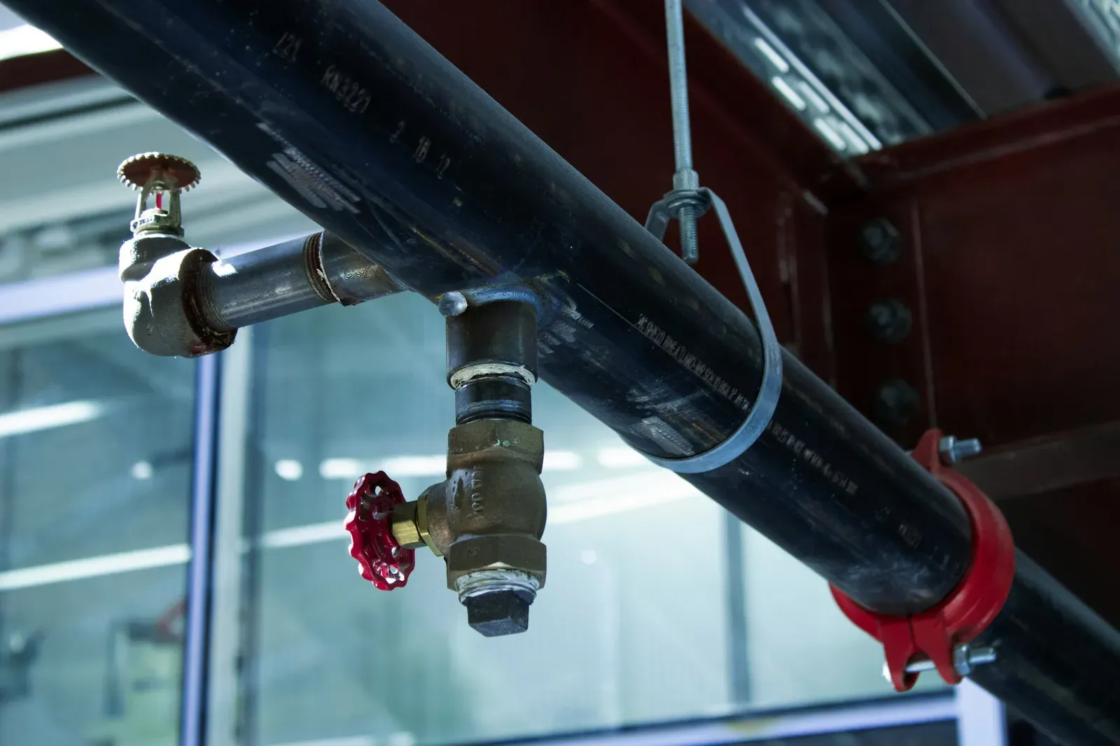 Industrial pipework with a red valve